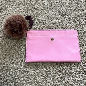 Pink zippered J.Crew clutch with removable faux fur pom, like new.